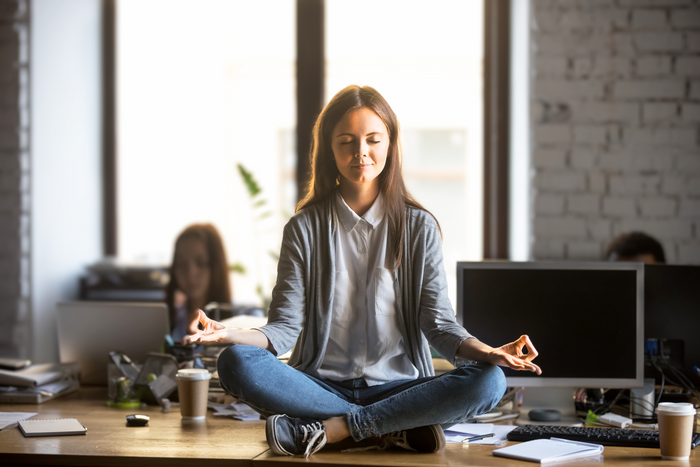 Image Calm woman meditating in a serene setting, symbolizing relaxation, balance, and mindfulness supported by CBD wellness products.
