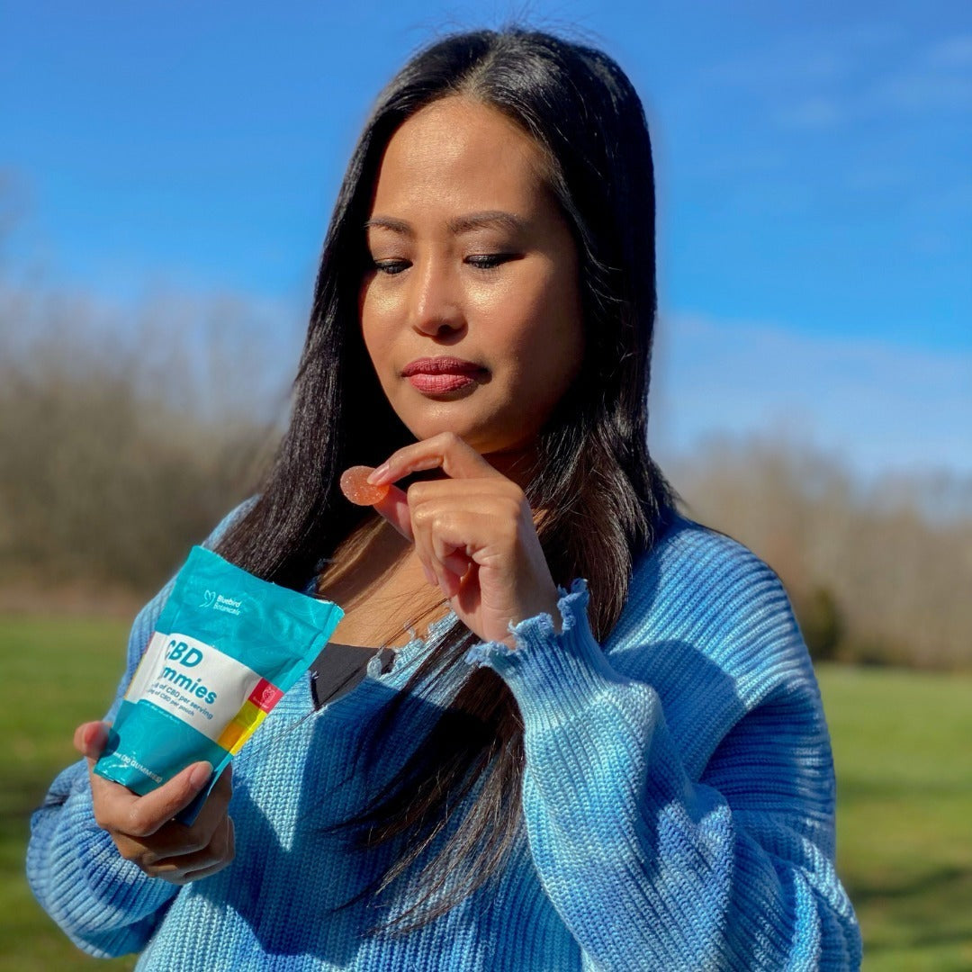 Girl holding bluebird botanical CBD gummies