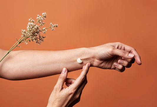 Close-up of a woman applying CBD cream to her hand, showing soothing use of topical CBD balm for skin and joint relief.