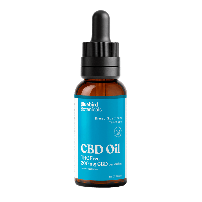 CBD oil bottle with dropper labeled 'Bluebird Botanicals' on a black background