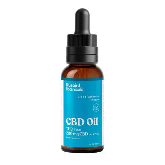 CBD oil bottle with dropper labeled 'Bluebird Botanicals' on a black background