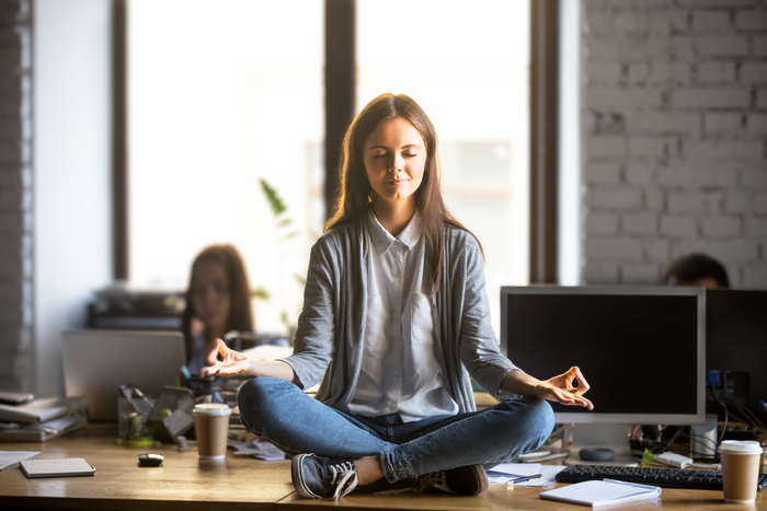 Woman on desk meditating quietly