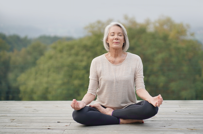 Woman meditating outdoors in a serene environment